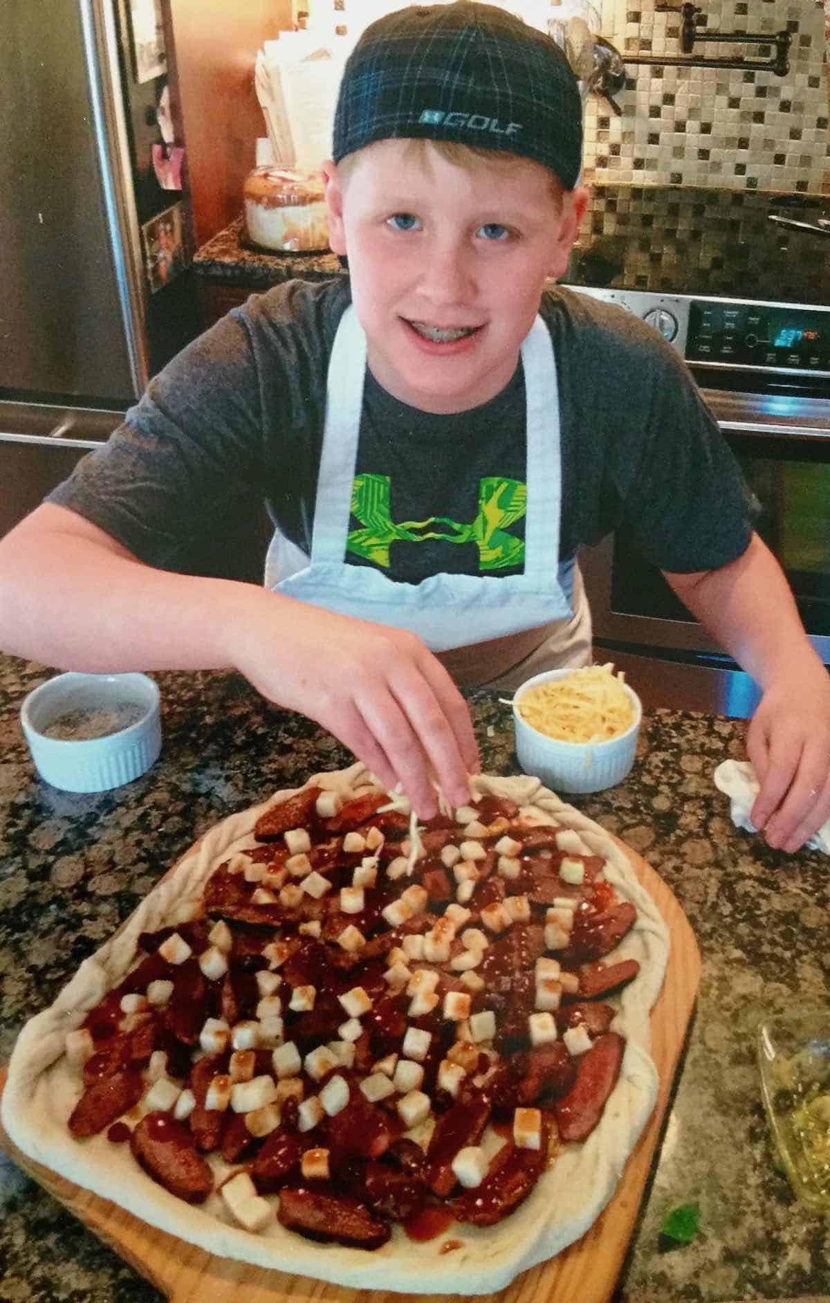 Aidan making pizza.