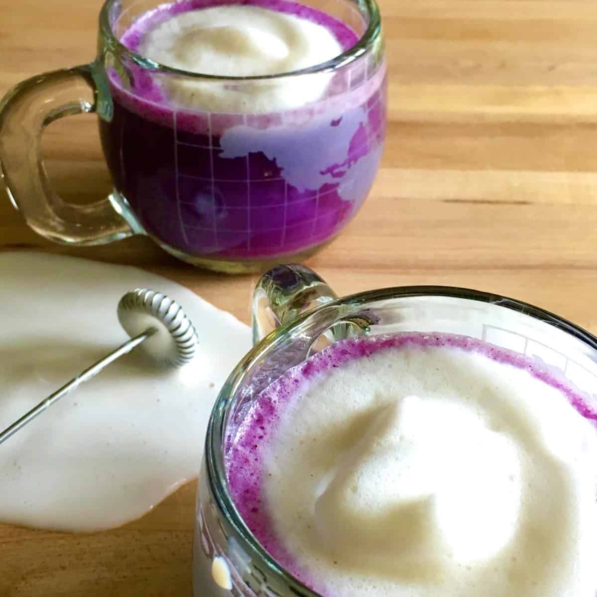 Blueberry latte with spilled milk.