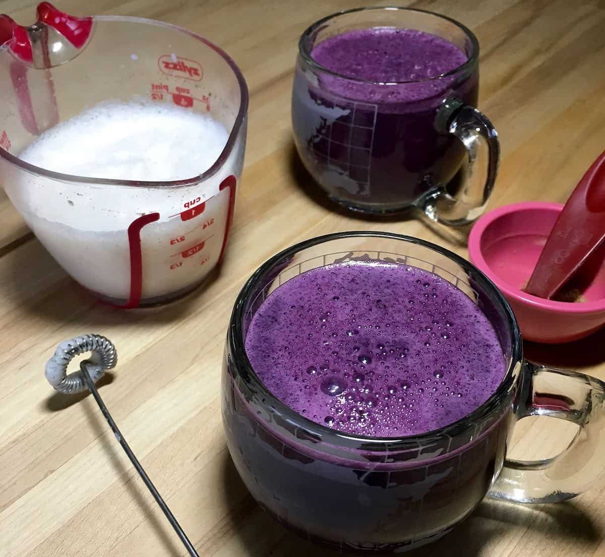 Blueberry latte ingredients and milk froth.