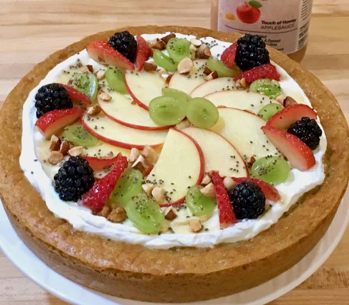 Fresh fruit topped cake made with applesauce.