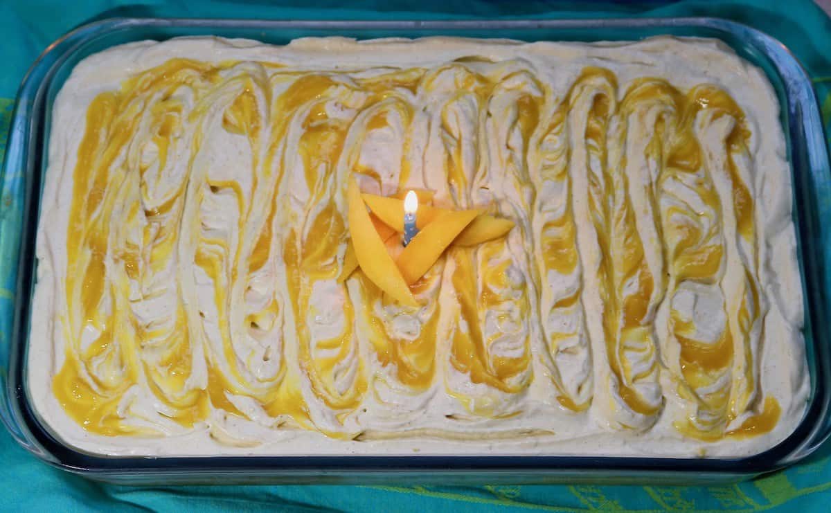 Mango tres leches cake with a birthday candle. Perfect pairings.