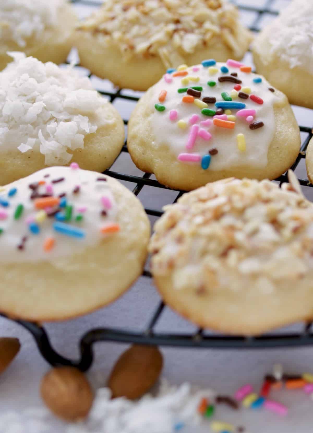 Italian Easter cookies on cooling rack with almonds.