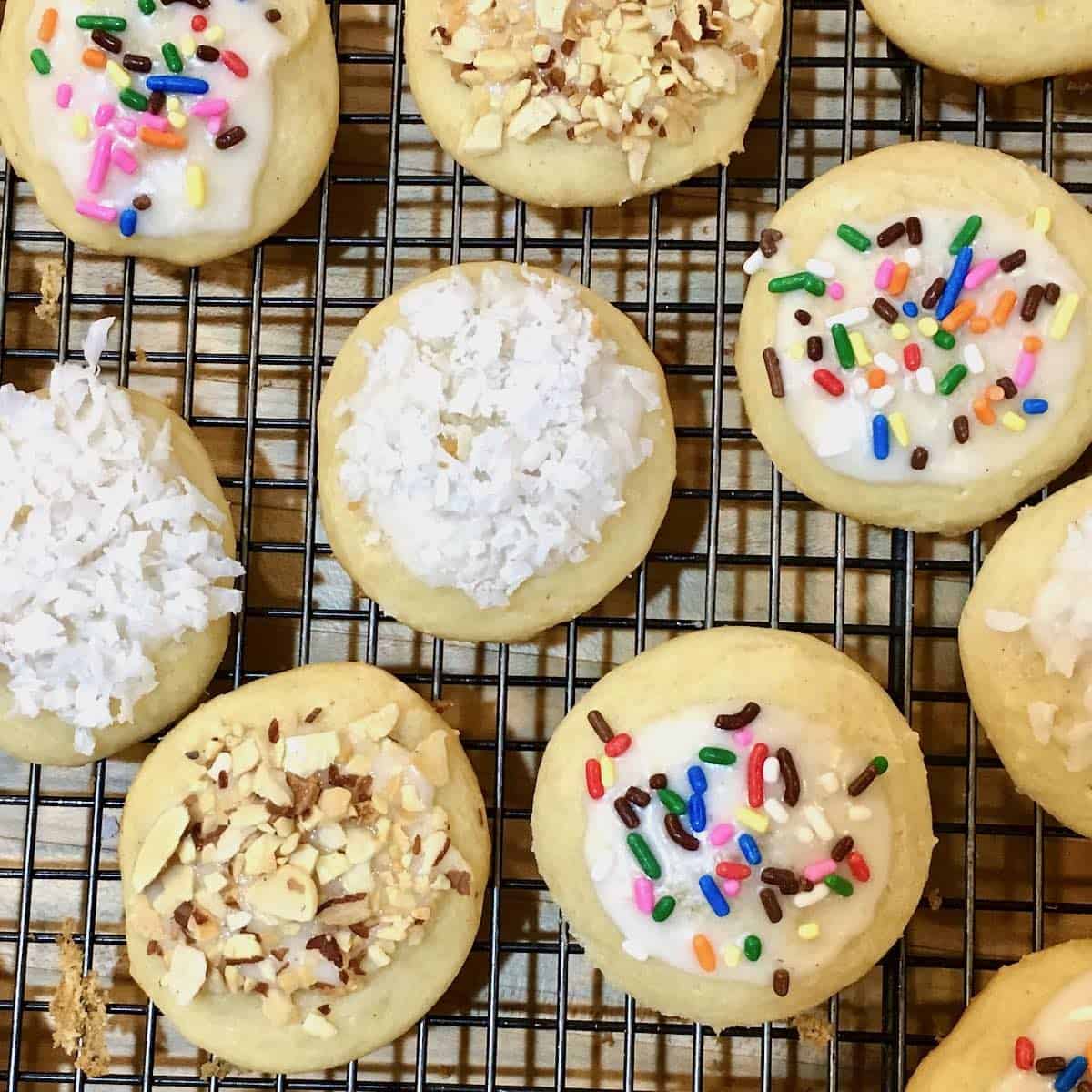 Over head view of cookies topped with coconut and sprinkles.
