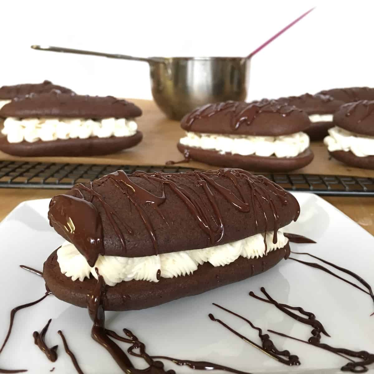 Chocolate drizzled homemade devil dogs.