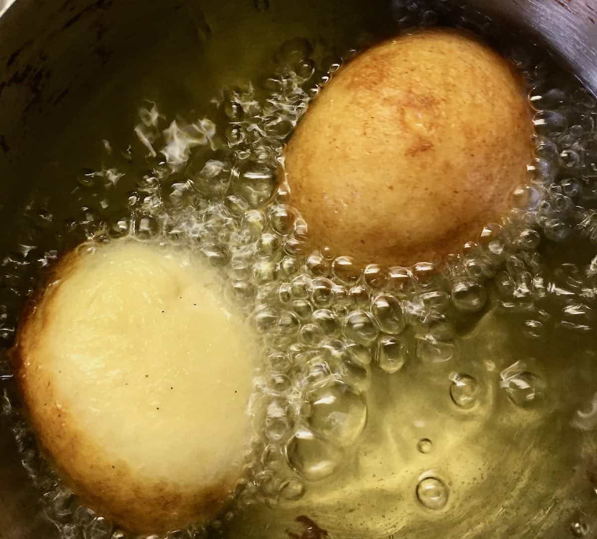 Deep frying fritters.