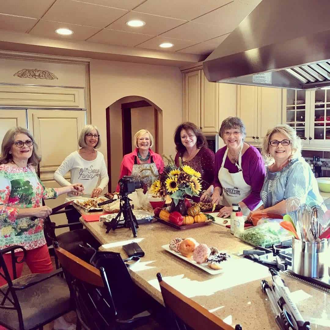 Friends cooking together and sharing stories and wisdom.