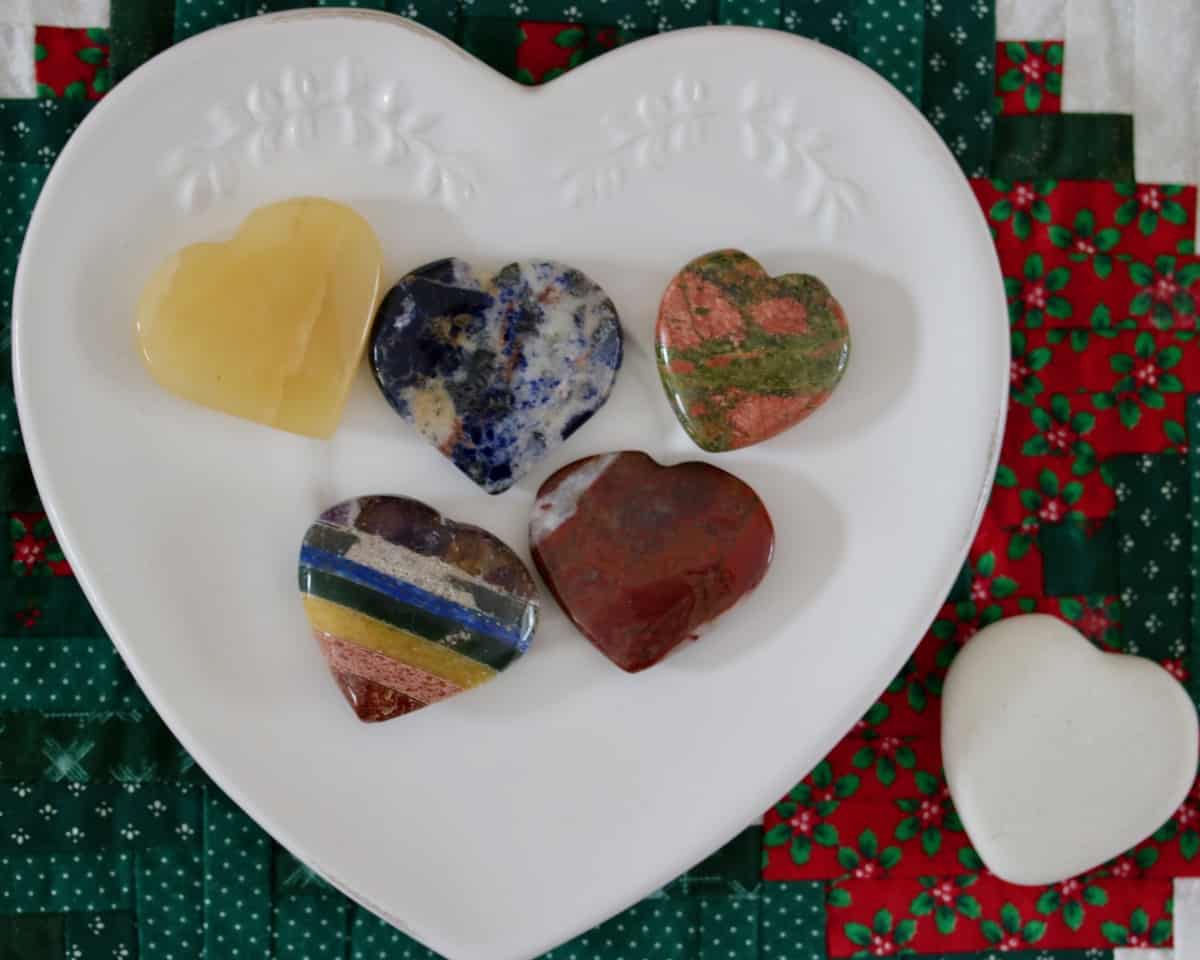 Polished rock hearts on a white heart plate.