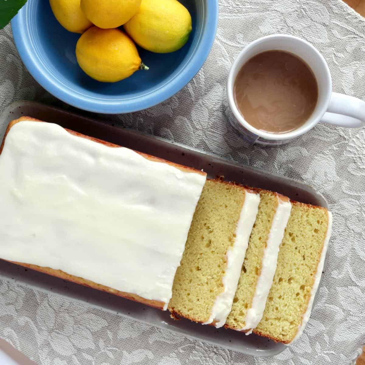 Sliced lemon cake with cup of coffee.