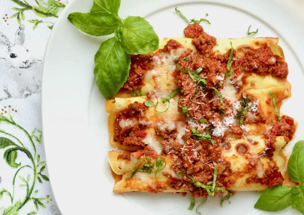 Plated manicotti with basil makes delicious Italian Easter dinner.