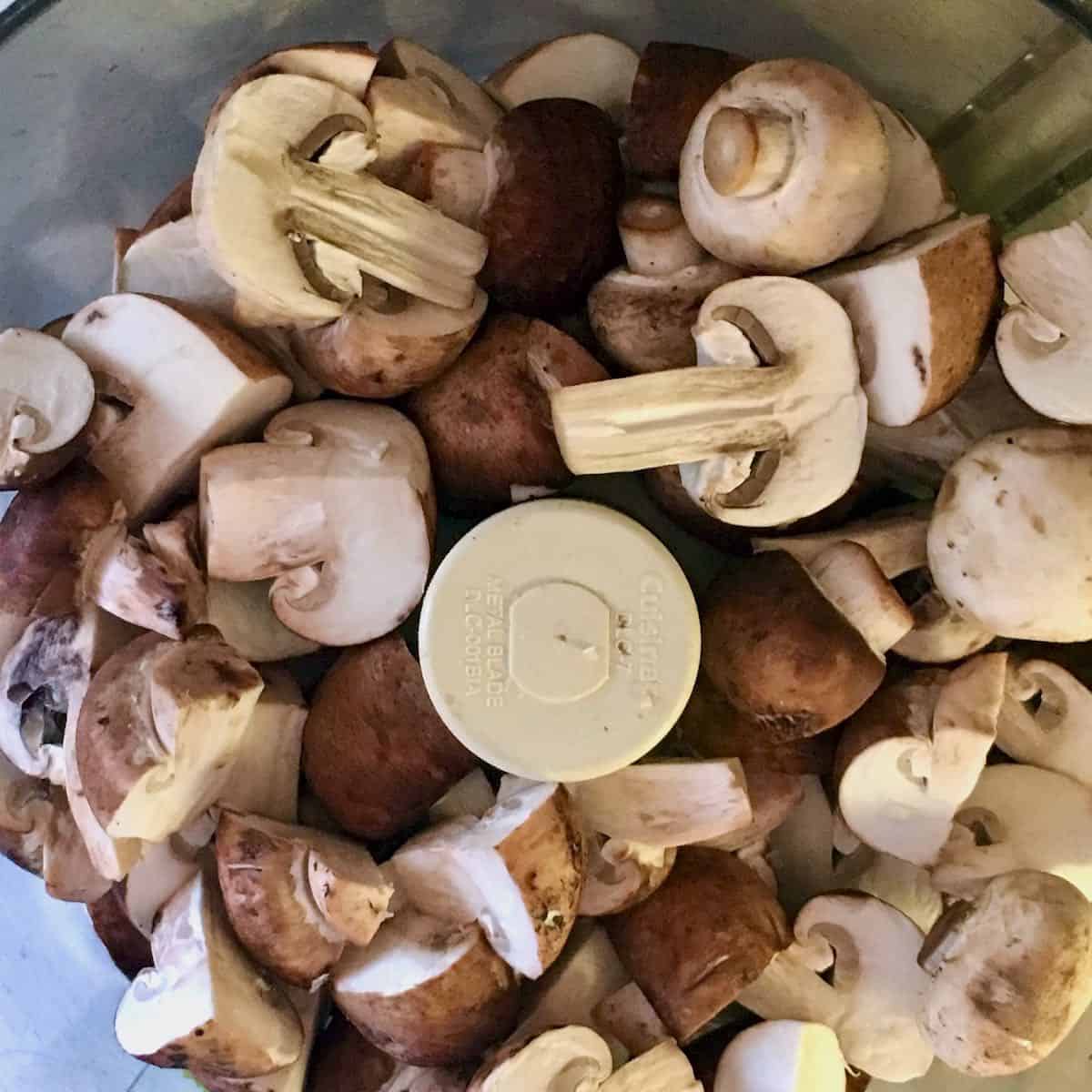 Sliced mushrooms in food processor.