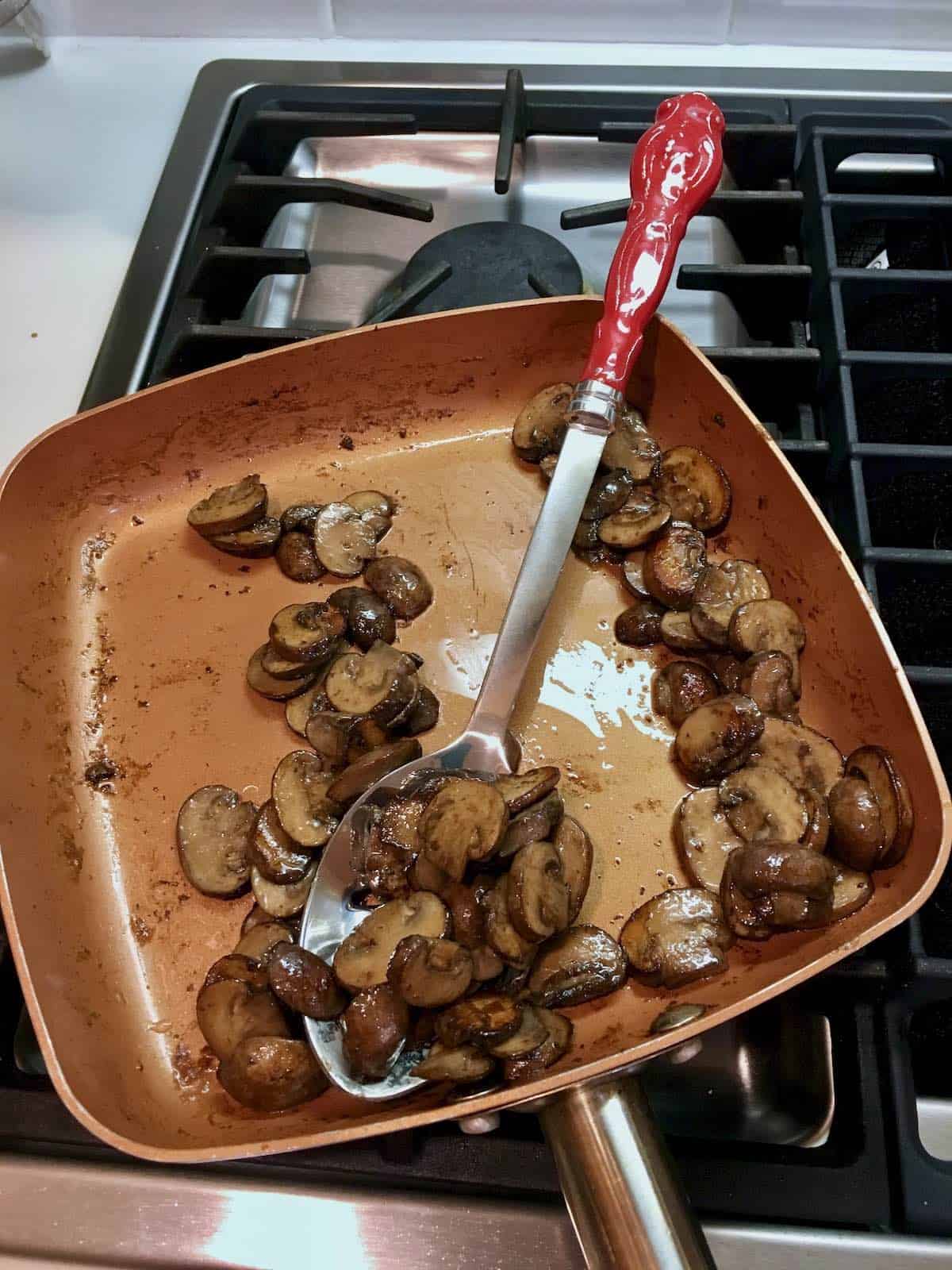 Cooked mushrooms in pan.