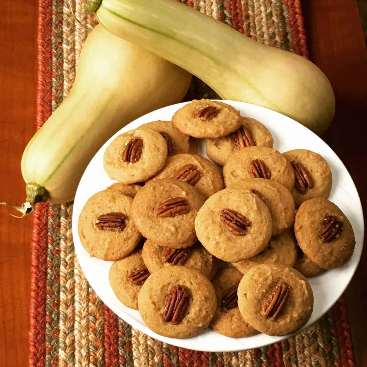 Plate of pecan cookies with fresh picked butternut squash.