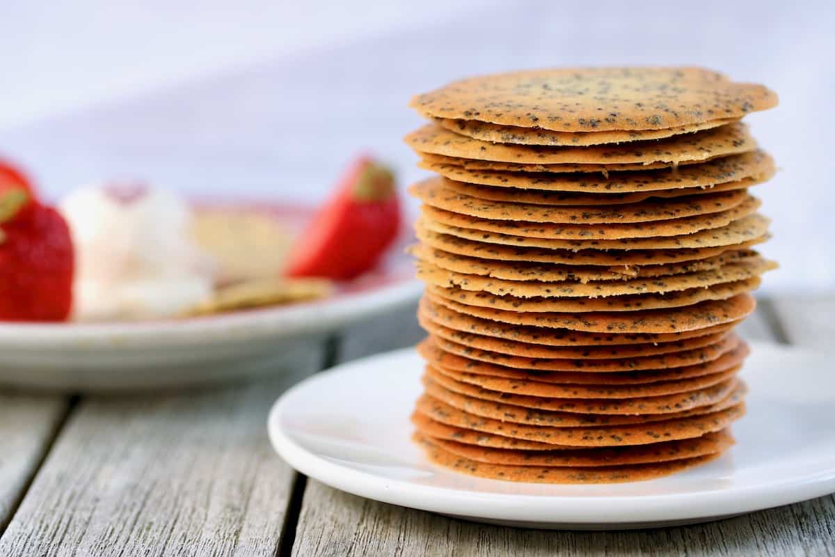 The best poppy seed cookies stacked on a plate.