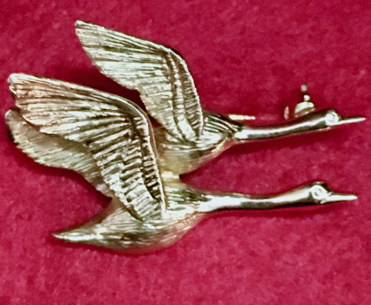 Geese mate for life gold pin.