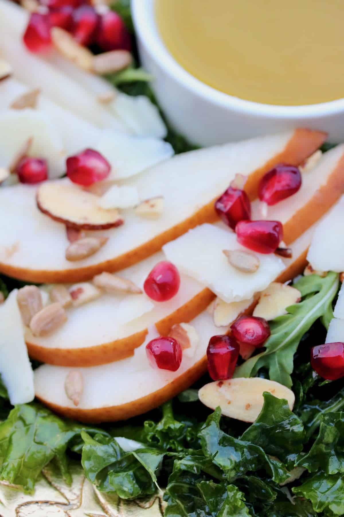 Pear salad with kale, pomegranate seeds, nuts.