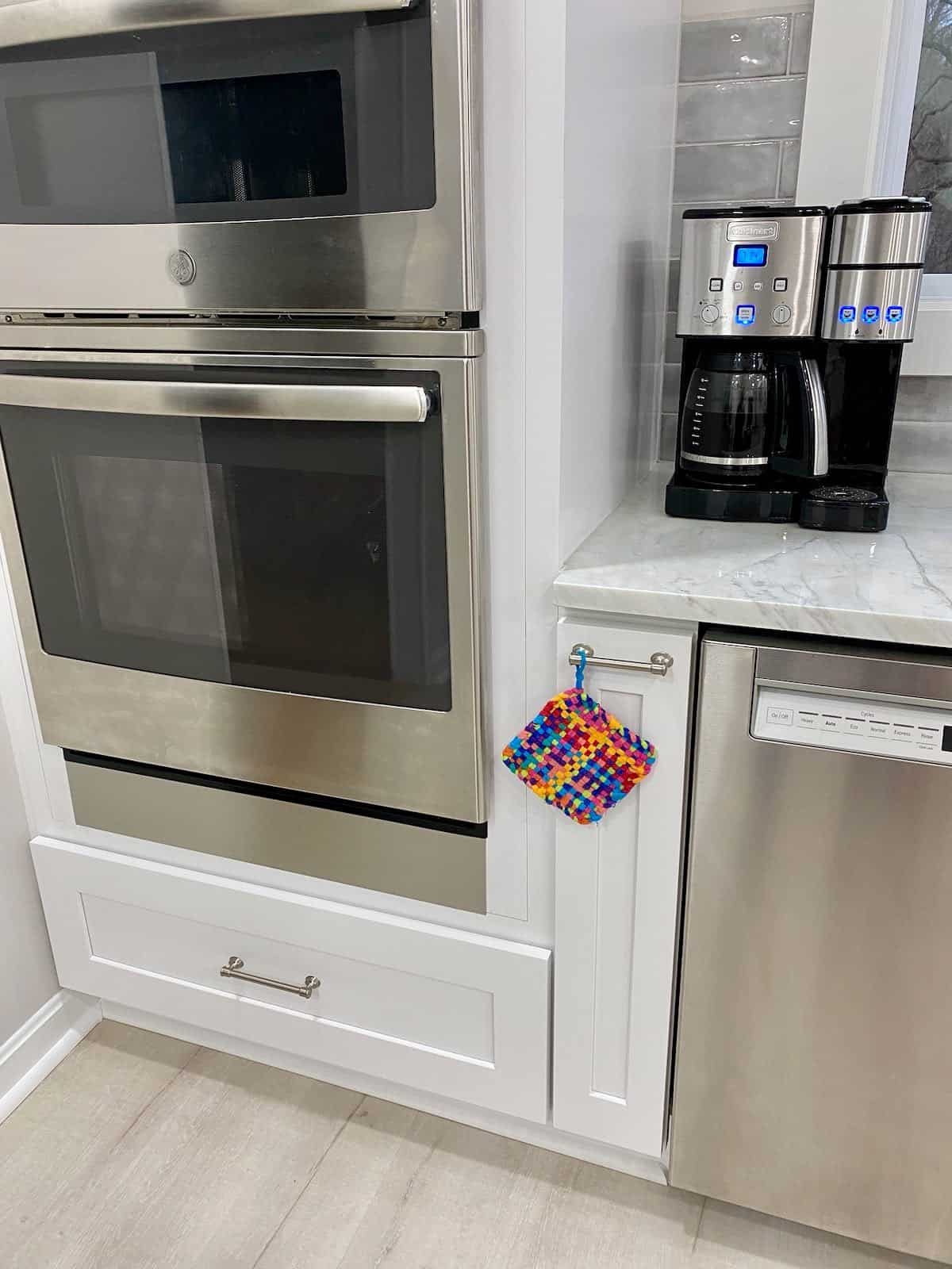 kitchen reveal with a rainbow potholder